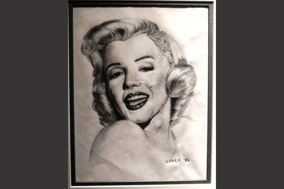 A pencil portrait of Marilyn Monroe drawn by Eric, signed and dated 1982, in a mat.